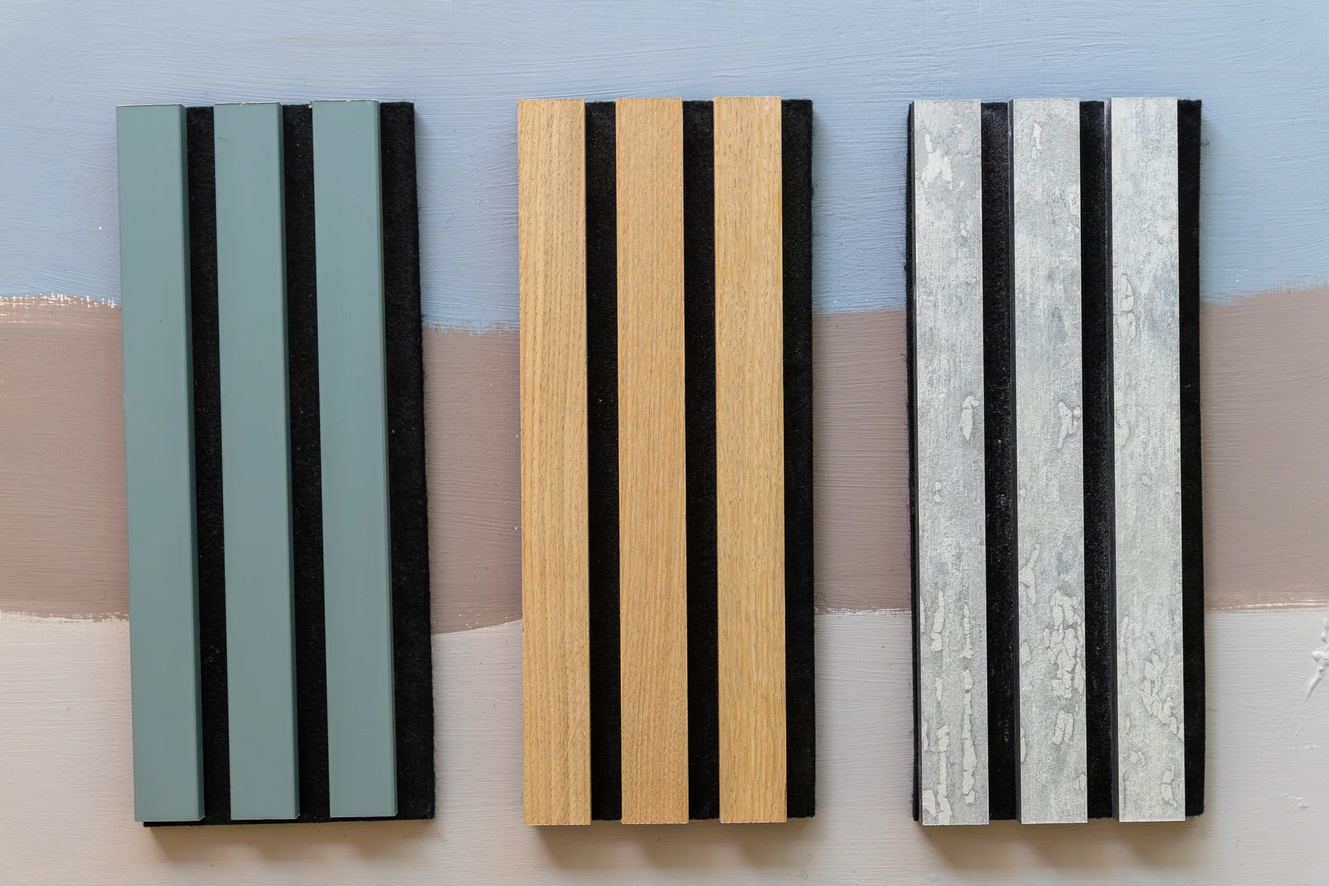 Three slat panel samples in sage, oak and concrete finishes